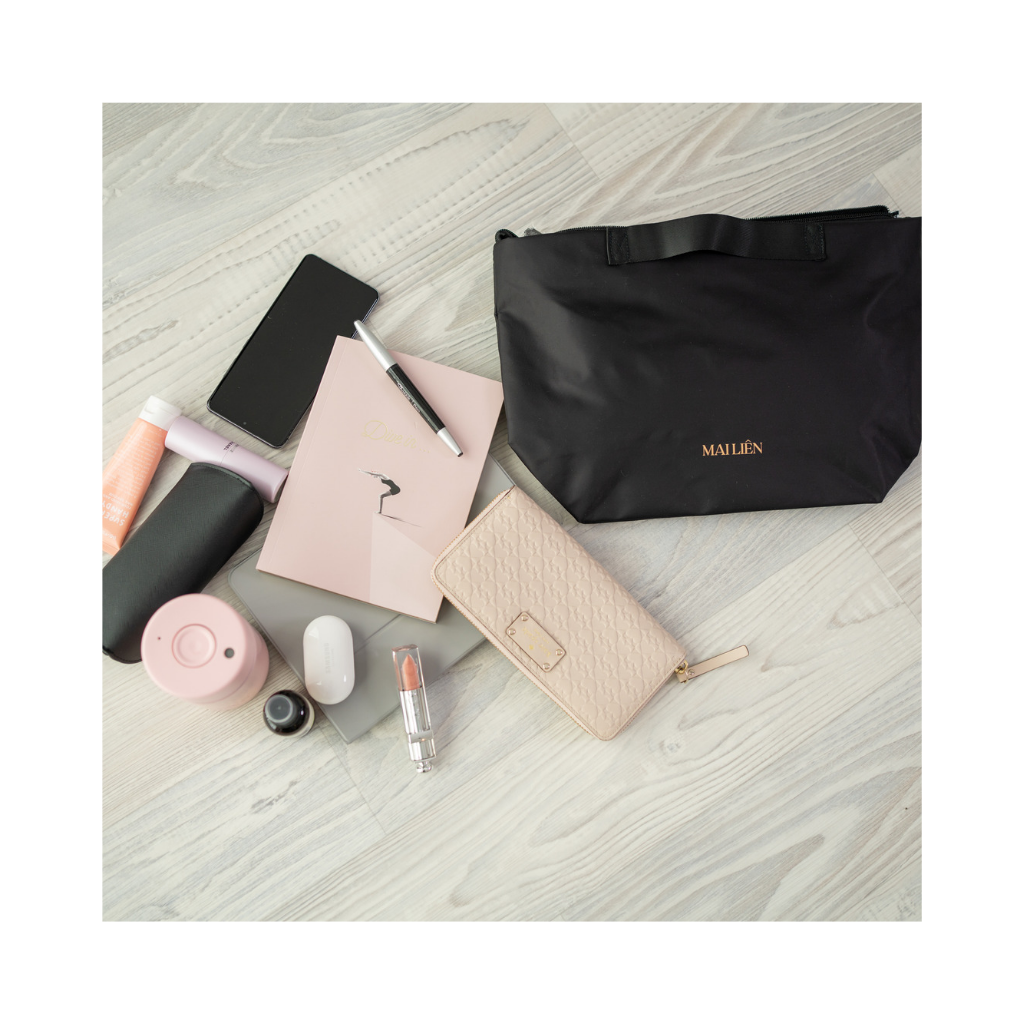 Black insert organiser/organizer bag layed on floor with items on the side next to it. Can buy from Mai Lien Co
