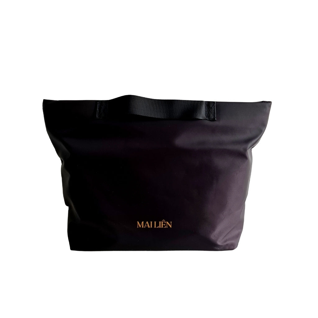 Photo of a Black Bag organiser/Organizer bag with handles. Nylon material. Light weight and waterpoof. Bag Keeps the contents of your handbag or tote organised and secure. Words on front Mai Lien Co