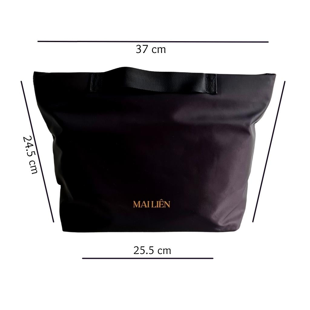 Photo of a Black Bag organiser/Organizer bag with handles. Nylon material. Light weight and waterpoof. Bag Keeps the contents of your handbag or tote organised and secure. Words on front Mai Lien Co. Size is 37cm by 25.5cm